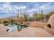 Inviting backyard pool with rock accents, desert landscaping, and stunning views at 7211 E Rising Star Way, Carefree, AZ 85377