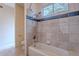 Bathroom featuring tile walls, a tub, and a window with natural light at 7211 E Rising Star Way, Carefree, AZ 85377