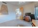 Bright bedroom with neutral walls, ceiling fan, and a wooden door at 7211 E Rising Star Way, Carefree, AZ 85377