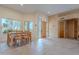 Elegant dining area featuring wooden table and chairs, seamlessly connects to the main entryway, offering ample natural light at 7211 E Rising Star Way, Carefree, AZ 85377