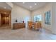 Bright dining room with wooden table and chairs, neutral walls, and stone tile flooring, perfect for Gathering gatherings at 7211 E Rising Star Way, Carefree, AZ 85377