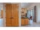 Bright kitchen area with natural wood cabinets and adjacent seating at the bar, blending functionality with casual style at 7211 E Rising Star Way, Carefree, AZ 85377