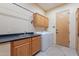 Functional laundry room with sink, cabinets, and appliances at 7211 E Rising Star Way, Carefree, AZ 85377