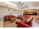 Open living room with a view of the kitchen, featuring comfortable red leather seating at 7211 E Rising Star Way, Carefree, AZ 85377