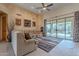 Stylish living room with textured walls, sliding glass doors to the patio, and neutral-toned furniture at 7211 E Rising Star Way, Carefree, AZ 85377