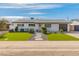 Charming single-story home with manicured lawn, and neutral paint at 7531 E Belleview St, Scottsdale, AZ 85257