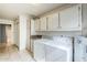 Well-lit laundry room with white cabinetry, sink, and tiled floors at 7629 N Via De La Campana --, Scottsdale, AZ 85258