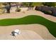 Overhead view of a backyard featuring desert landscaping, a turf grass lawn, and a patio with a table and chairs at 7910 E Snowdon Cir, Mesa, AZ 85207