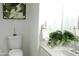 Bright bathroom featuring a white granite vanity top with potted plants and a large framed mirror above the sink at 7910 E Snowdon Cir, Mesa, AZ 85207