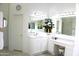 Bright bathroom with dual sink vanity, large mirror, and neutral countertops provides a spa-like feel at 7910 E Snowdon Cir, Mesa, AZ 85207