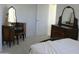 Bedroom featuring a dresser with lamps, bed with blankets, and natural lighting at 7910 E Snowdon Cir, Mesa, AZ 85207