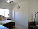 Bright bedroom with a ceiling fan, dresser with lamps, and natural lighting creates a calming atmosphere at 7910 E Snowdon Cir, Mesa, AZ 85207