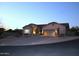 Well-maintained single-story home featuring desert landscaping as seen at dusk at 7910 E Snowdon Cir, Mesa, AZ 85207