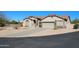 Single-story home featuring desert landscaping, a long driveway, and a neutral color palette at 7910 E Snowdon Cir, Mesa, AZ 85207