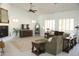 Open living room featuring a fireplace, plantation shutters, and a comfortable sofa at 7910 E Snowdon Cir, Mesa, AZ 85207