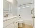 Well-lit bathroom featuring tiled floors, a marble vanity top, and a tub with shower at 8661 N 108Th Ln, Peoria, AZ 85345