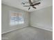 Well-lit bedroom with neutral carpet and a large window with shutters at 8661 N 108Th Ln, Peoria, AZ 85345