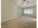 Bright bedroom with neutral carpet, ceiling fan, and window shutters, creating a cozy and inviting atmosphere at 8661 N 108Th Ln, Peoria, AZ 85345