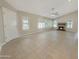 Bright living room features tile floors, multiple windows with shutters, and a cozy fireplace at 8661 N 108Th Ln, Peoria, AZ 85345