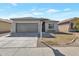 Charming single-story home with a gray exterior, well-manicured yard, and a two-car garage at 9121 W Alvarado St, Phoenix, AZ 85037