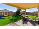 Inviting backyard patio with cozy seating and a well-manicured lawn at 9853 W Irma Ln, Peoria, AZ 85382