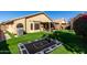 Expansive backyard featuring green lawn, hardscape patio, and trampoline for outdoor fun at 9853 W Irma Ln, Peoria, AZ 85382