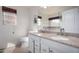 Bright bathroom features a double sink vanity with granite countertop and tiled floors at 9853 W Irma Ln, Peoria, AZ 85382