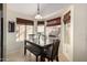 Charming dining area with natural light, wooden table, bench seating and views of the backyard at 9853 W Irma Ln, Peoria, AZ 85382