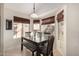 Charming dining area with natural light, wooden table, bench seating and views of the backyard at 9853 W Irma Ln, Peoria, AZ 85382