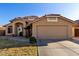 Charming single-story home featuring a tile roof, two-car garage, and well-manicured landscaping at 9853 W Irma Ln, Peoria, AZ 85382