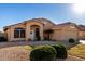 Well-maintained home with a tile roof, desert landscaping, and a welcoming front entrance at 9853 W Irma Ln, Peoria, AZ 85382