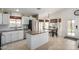 Bright kitchen with an island, stainless steel appliances, and an adjacent dining area filled with natural light at 9853 W Irma Ln, Peoria, AZ 85382