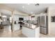 Modern kitchen featuring a central island, stainless steel appliances, and an open-concept design at 9853 W Irma Ln, Peoria, AZ 85382