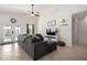 Cozy living room featuring a sectional sofa, tile flooring, and natural light at 9853 W Irma Ln, Peoria, AZ 85382