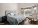 Relaxing main bedroom featuring hardwood floors, a bay window seat, and soothing natural light at 9853 W Irma Ln, Peoria, AZ 85382