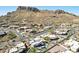 Overhead view of desert homes with pools, landscaping, and mountain backdrop at 9870 E Little Nugget Way, Gold Canyon, AZ 85118