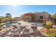 Inviting backyard with a pool, lounge chairs, and pergola-covered outdoor kitchen at 9870 E Little Nugget Way, Gold Canyon, AZ 85118