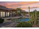 Gorgeous backyard pool with an attached covered patio and desert landscaping; perfect for outdoor relaxation at 9870 E Little Nugget Way, Gold Canyon, AZ 85118