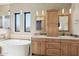 Spacious bathroom with dual sinks, a soaking tub, and pendant lighting at 9870 E Little Nugget Way, Gold Canyon, AZ 85118