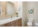 Well-lit bathroom with granite countertops, decorative mirror and modern fixtures at 9870 E Little Nugget Way, Gold Canyon, AZ 85118