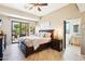 Comfortable bedroom featuring wood floors, dark wood furniture, and a sliding glass door leading to outdoor space at 9870 E Little Nugget Way, Gold Canyon, AZ 85118