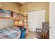 Bedroom with a rustic bunk bed, closet, and seating area with a comfortable chair at 9870 E Little Nugget Way, Gold Canyon, AZ 85118