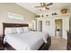 Bedroom with wood-look floors and earth tone walls with walk-in closet and hallway entries at 9870 E Little Nugget Way, Gold Canyon, AZ 85118