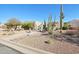 Southwestern home with desert landscaping, including cacti, mature trees, and rock accents at 9870 E Little Nugget Way, Gold Canyon, AZ 85118