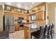 Modern kitchen with stainless steel appliances, granite counters and wooden cabinets at 9870 E Little Nugget Way, Gold Canyon, AZ 85118