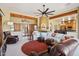 Inviting living room with beamed ceilings, a corner fireplace and large sectional sofa at 9870 E Little Nugget Way, Gold Canyon, AZ 85118