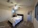 Cozy bedroom featuring a ceiling fan, window, carpet and a closet with doors at 10731 W Wikieup Ln, Peoria, AZ 85373