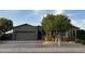 Charming single-story home featuring desert landscaping, a private entry gate and two-car garage at 10731 W Wikieup Ln, Peoria, AZ 85373