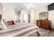 View of bedroom with ceiling fan, wood floors, ensuite bathroom and large wood dresser at 11026 E Nopal Ave, Mesa, AZ 85209