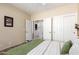 Bedroom featuring wood floors, ceiling fan, view of closets and in-suite laundry at 11026 E Nopal Ave, Mesa, AZ 85209